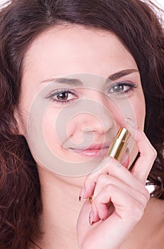 Young woman with perfume bottle