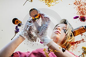 Woman perfumer preparing herbs and flowers for make a perfume.