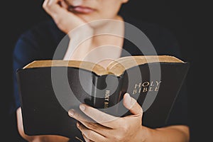 Young woman person hand holding holy bible with study at home. Adult female christian reading book in church. Girl learning