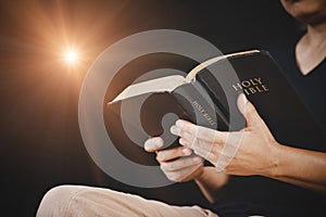 Young woman person hand holding holy bible with study at home. Adult female christian reading book in church. Girl learning