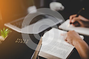 Young woman person hand holding holy bible with study at home. Adult female christian reading book in church. Girl learning