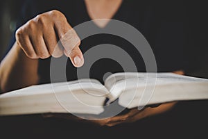 Young woman person hand holding holy bible with study at home. Adult female christian reading book in church. Girl learning