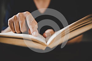 Young woman person hand holding holy bible with study at home. Adult female christian reading book in church. Girl learning