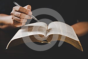 Young woman person hand holding holy bible with study at home. Adult female christian reading book in church. Girl learning