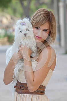 Young woman with pet Maltese dog