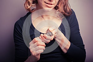 Young woman with pet mouse