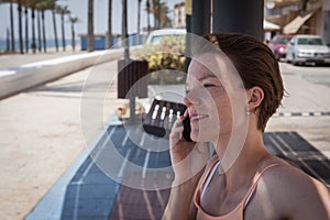 Young woman phone on beach bench