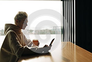 Young woman on the phone in cafe