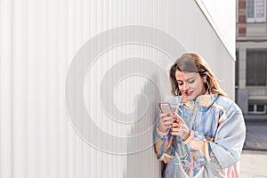 Young woman with phone outdoors