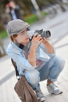 Young woman photo reporter in town working