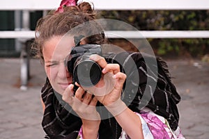 Young woman photographer with camera