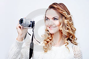 Young woman photographer with camera, portrait on white background