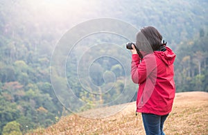 Young woman photographer take forest picture