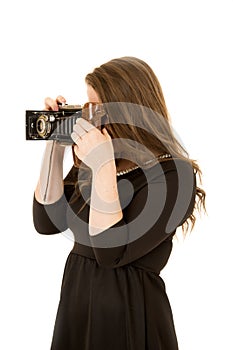 Young woman photographer taking picture with antique camera