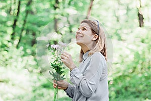 Young woman picking flowers in nature