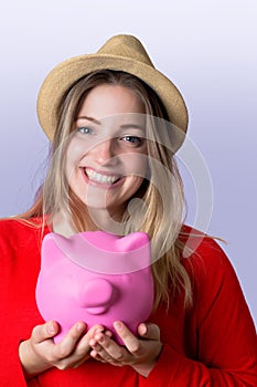 Young woman with piggy bank