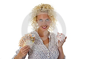 Young woman with piggy bank and euro banknotes