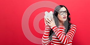 Young woman with a piggy bank