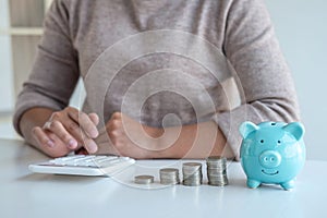 Young woman and piggy bank to planning growing saving strategy with pile coins for future plan fund of travel, education, home and