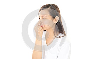 Young woman pinches her nose photo