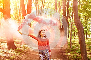 Young woman with pink color smoke bomb