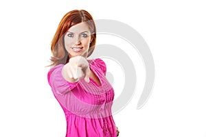 Young woman in pink dress pointing a finger at you