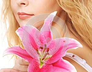 Young woman with pink lily