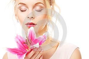 Young woman with pink lily isolated on white