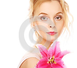 Young woman with pink lily isolated on white