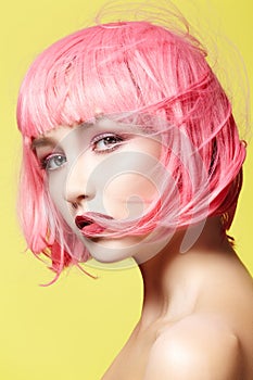 Young woman in pink wig. Beautiful model with fashion makeup. Bright spring look. hair color, medium hairstyle