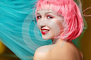 Young woman in pink wig. Beautiful model with fashion makeup. Bright spring look. hair color, medium hairstyle