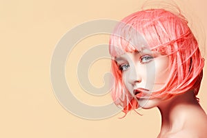 Young woman in pink wig. Beautiful model with fashion makeup. Bright spring look. hair color, medium hairstyle