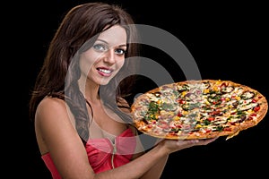 Young woman with pizza against black background