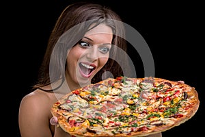 Young woman with pizza against black background