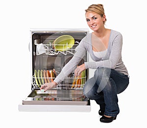 Young Woman Placing Soap In Dishwasher photo