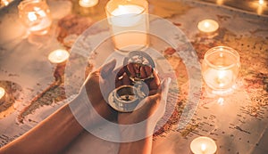 Young woman planning world tour with vintage travel map - Traveler girl using compass with candles in background - Wanderlust,