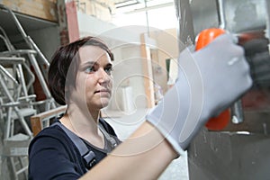 Young woman plasterer working