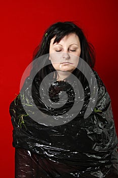 Young woman in a plastic bag