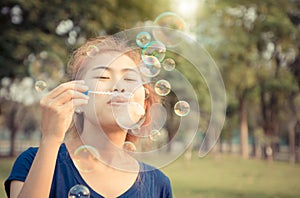 Young woman play blowing bubble outdoor lifestyle vintage color