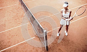 young woman play tennis on tennis court