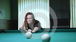 Young woman playing billiard game