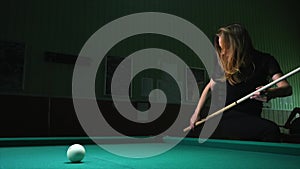 Young woman playing billiard game