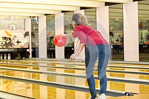 young woman playing bowling alone