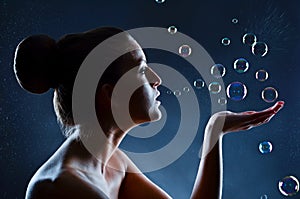 Young woman playing with bubbles portrait