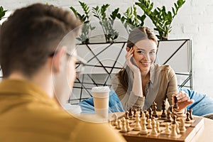 young woman playing chess and flirting photo