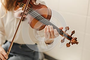 Young Woman Playing Classical Instrument Violin or Bluegrass Fiddle