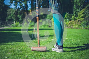 Young woman playing croquet