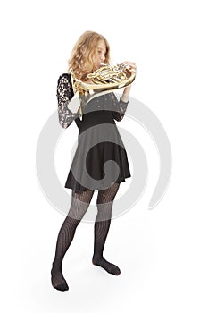 Young woman playing french horn