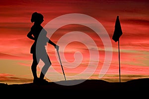 Of a young woman playing golf on the evening sky with pink shades