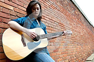 Young Woman Playing Guitar